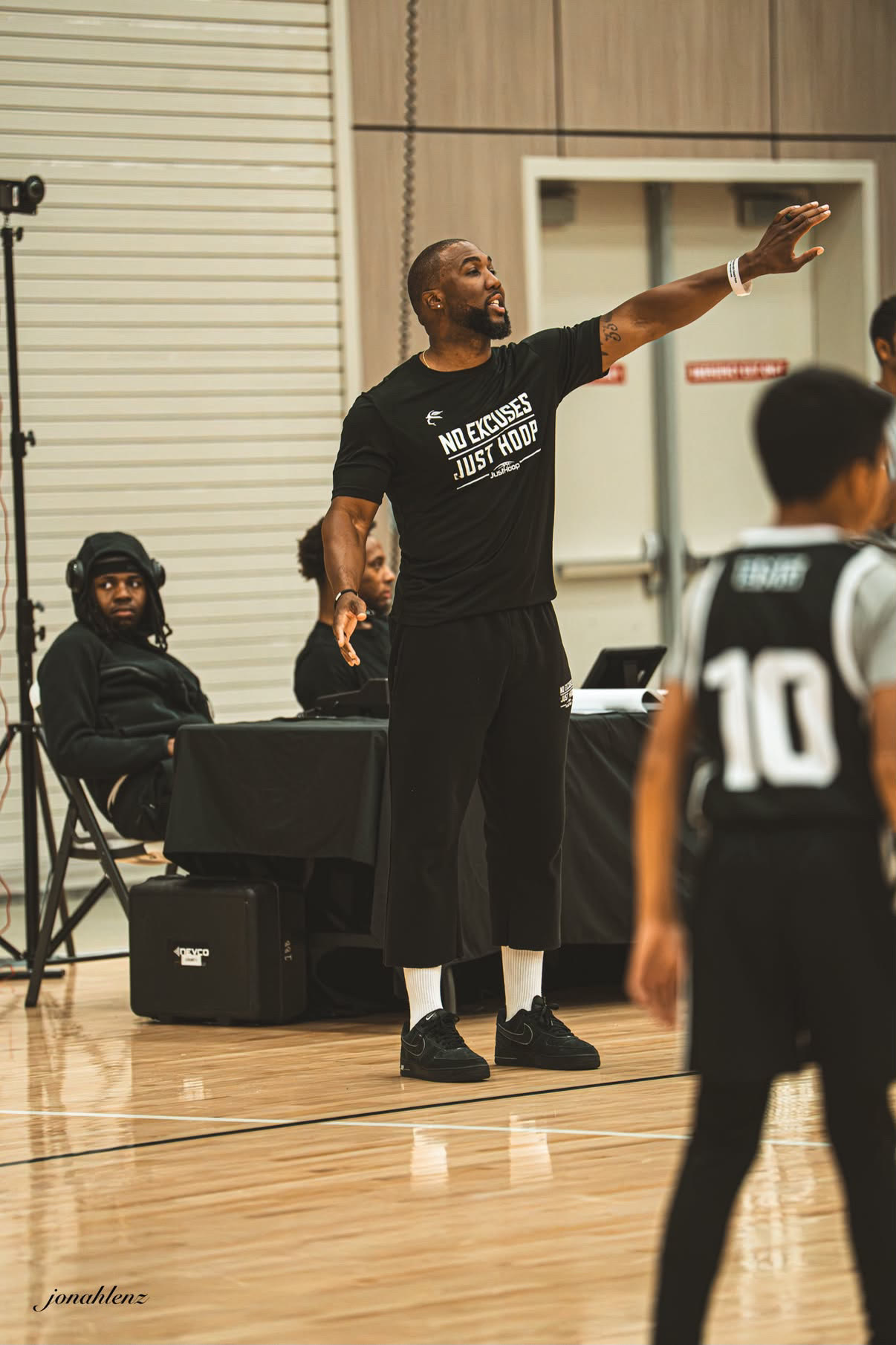 A Just Hoop coach directing players during a small-group session