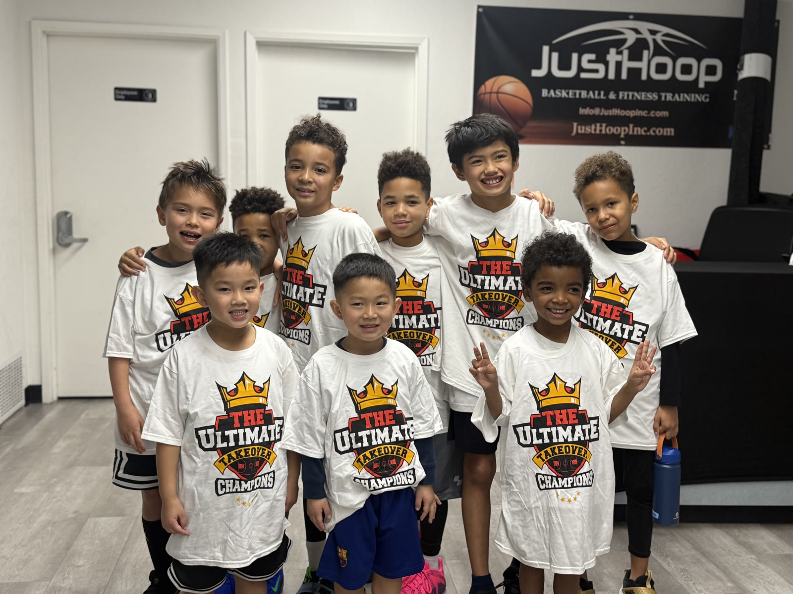 Young Just Hoop players in Ultimate Takeover Champions shirts under the JustHoop banner