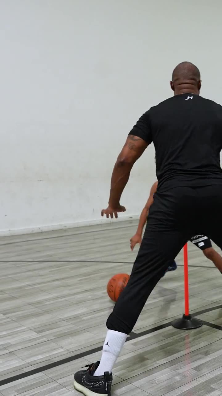 A young player attacking the cone-and-pole ball-handling drill in a private session