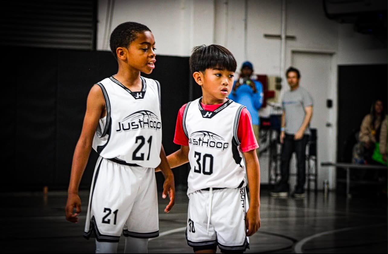 Two young Just Hoop players side by side during a game