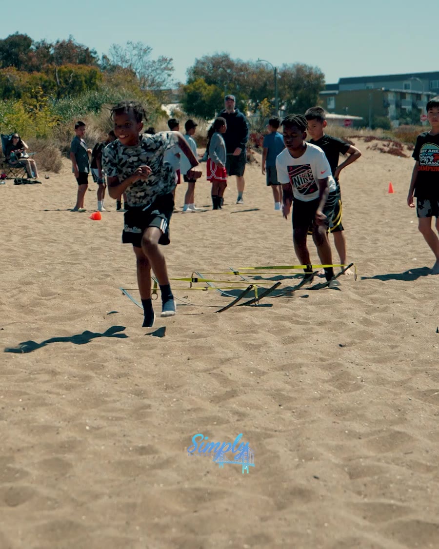 JustHoop players running conditioning drills on the beach